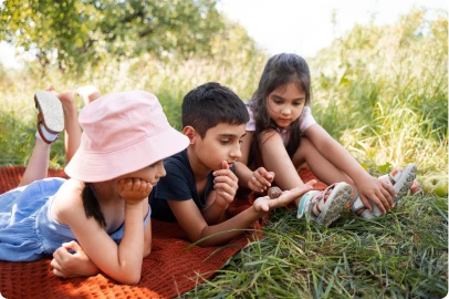 Young children exploring plants and nature in a garden during a Cops 'n Kids activity
