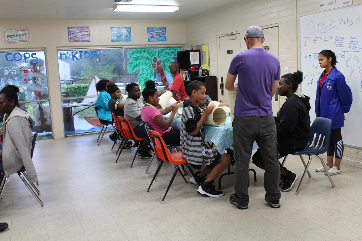 Children seated in rows attending an indoor Cops 'n Kids program session