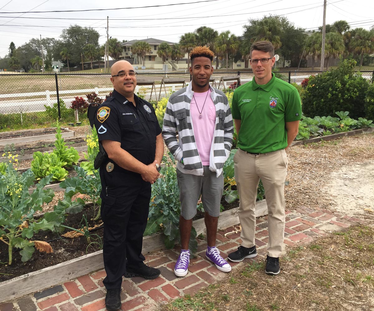 Police officer and community volunteer standing together in the Cops 'n Kids garden