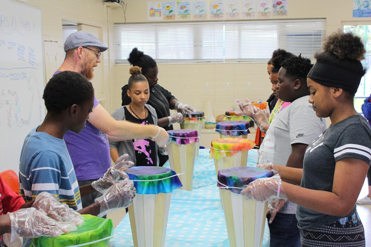Children and adults operating a lemonade stand at a Cops 'n Kids community event