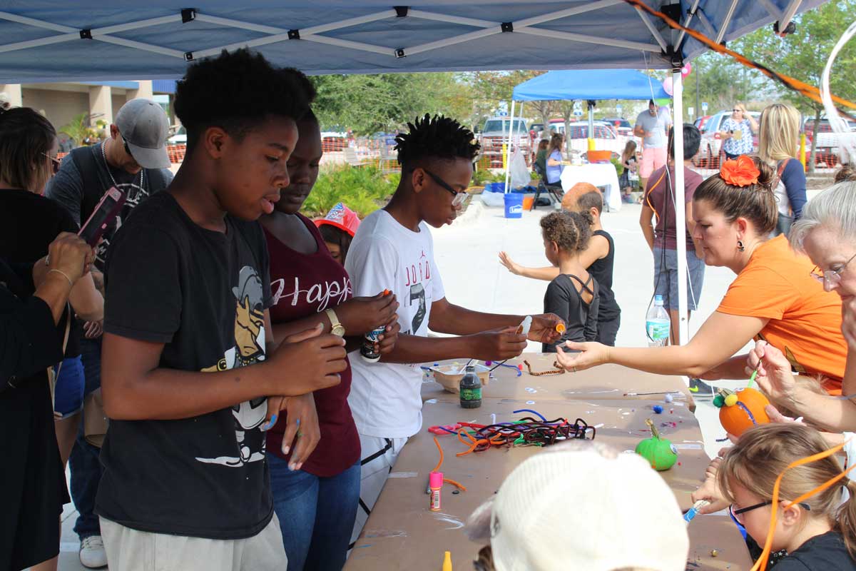 Children participating in arts and crafts activities at a Cops 'n Kids outdoor event